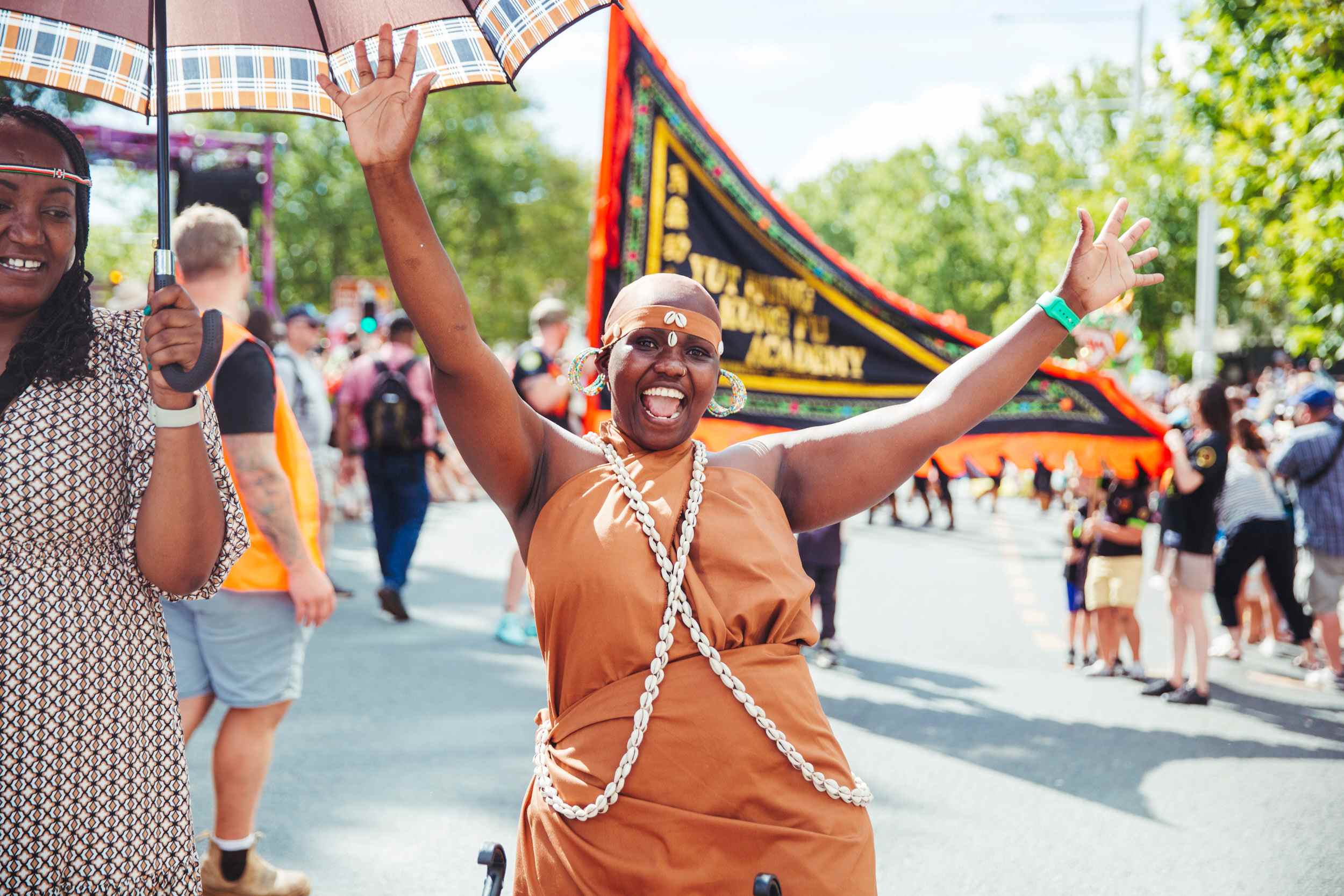 Parade participant looking excited with their hands up